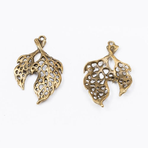Filigree Leaves metal component, reverse and front details on a white background.