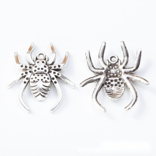Front and reverse details of spider charms on a white background