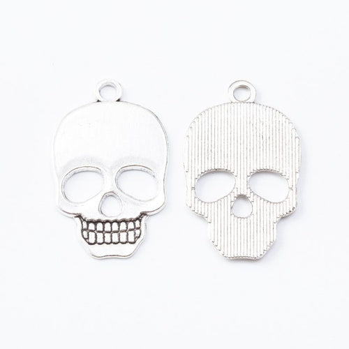 Closer product view of square skull charm shown against a plain background.