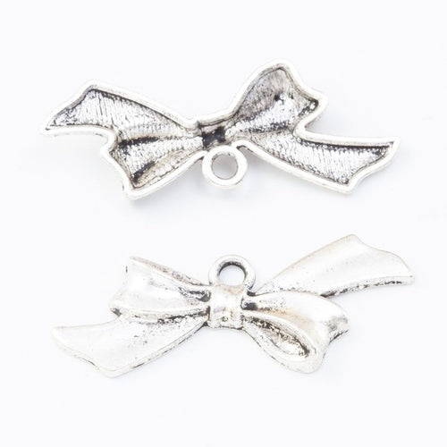 Wide tied bow charms with folded ribbon tails and a center loop shown from the front on a white background.