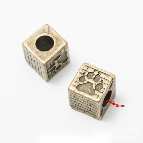 Front and reverse details of mixed motif beads on a white background