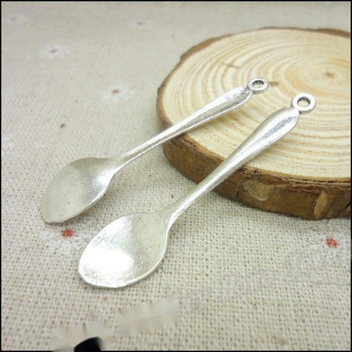 Product photo 2 of the long handle spoon charm highlighting its plain miniature spoon with a loop at the handle end