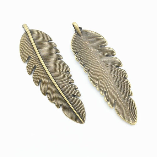 Large feather metal component, front and reverse detail on white