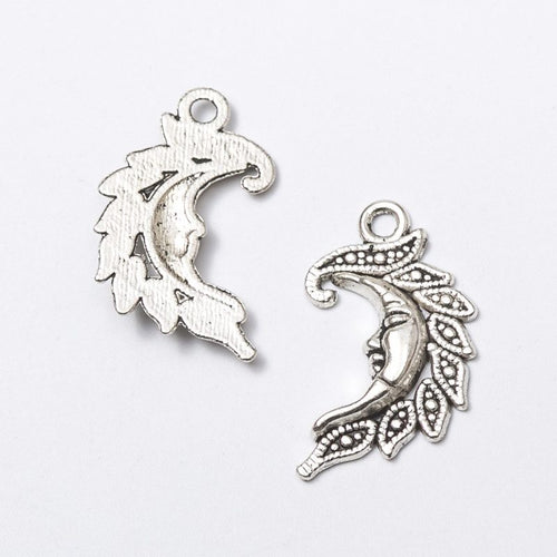 Detail view of filigree crescent moon charm showing finish variation 2