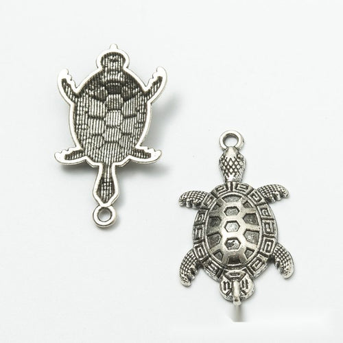 Turtle Charm Pendant front detail showing a patterned shell, four flippers, and a small tail