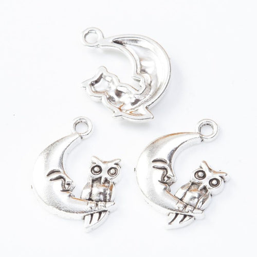 Front and reverse details of owl moon charms on a white background
