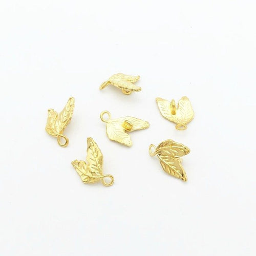 Close view showing the front and reverse details of the double leaf charm