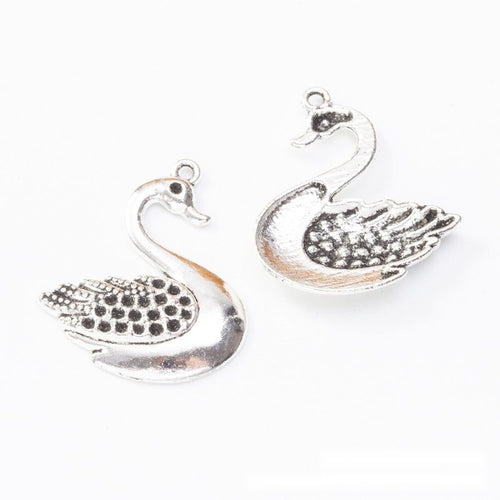 Close front view of swan charm showing a curved neck and dotted wing texture