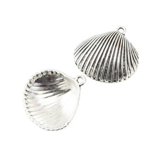 Close front view showing the shape and recessed details of the hinged scallop shell charms