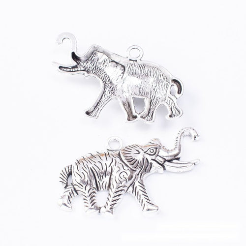 Walking elephant charms with raised trunks and textured blankets shown from the front on a white background.