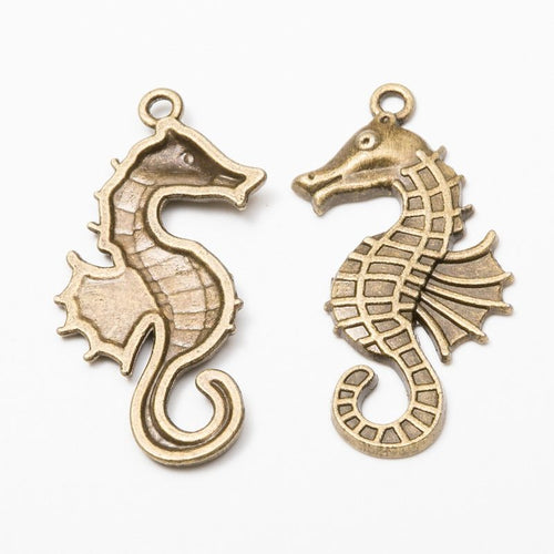 Curled seahorse charms with segmented bodies and ridged fins shown from the front on a white background.