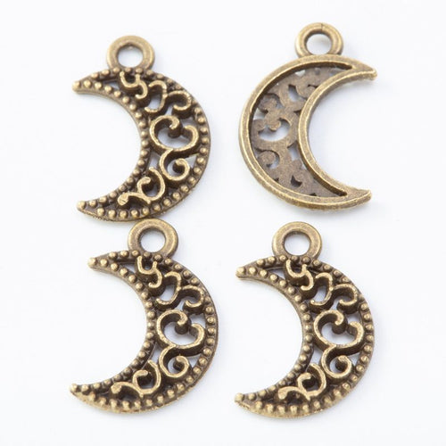 Close front view of crescent moon charm showing scrolling openwork and a top loop