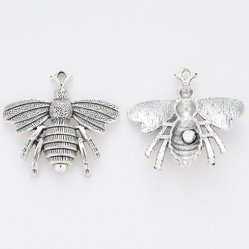 Close front and reverse view of the metal bee charm