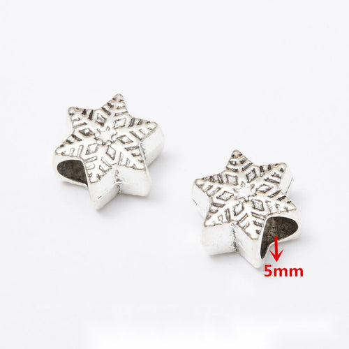 Front and reverse details of winter theme beads on a white background