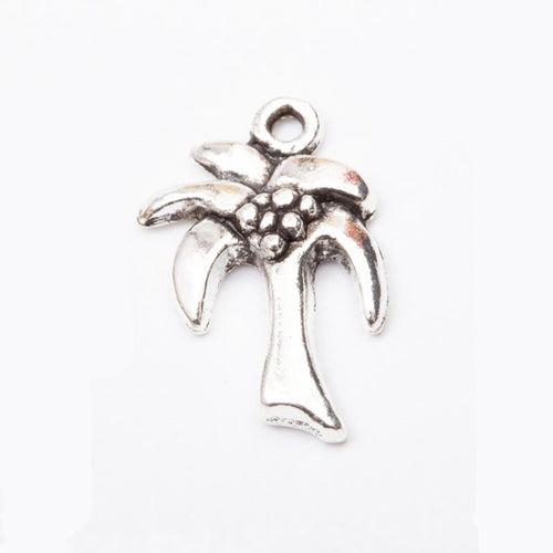 Close product view of the palm tree pendant charm in two antique metal finishes
