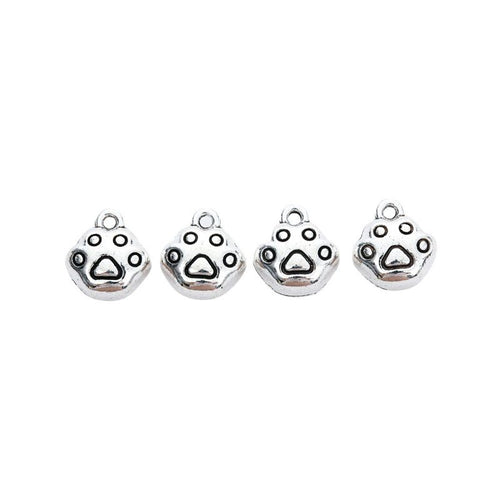 Grouped view of the round paw print metal charm from the front
