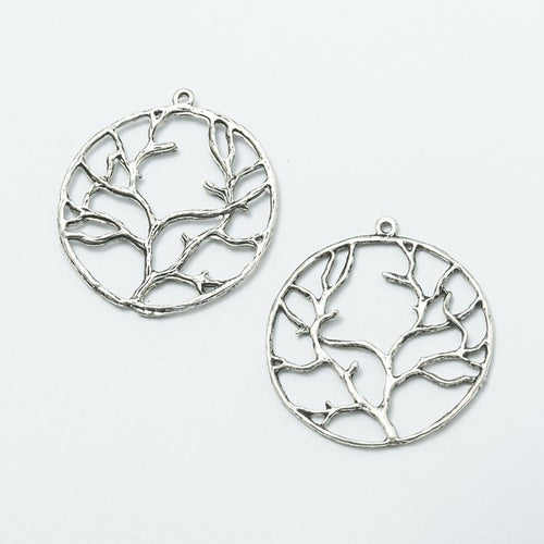 Close-up view of the round branching tree metal charms in two finishes showing its front and reverse metal details.