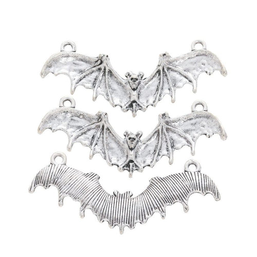 Grouped front and back views showing the details of three flying bat charms
