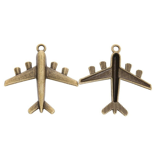 Close view showing the front and reverse details of the airplane charm