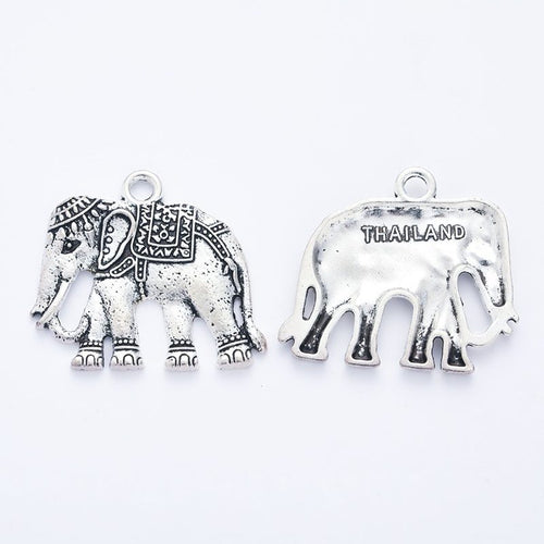 Product photo 2 of the decorated elephant charm highlighting its walking elephant with engraved blanket and THAILAND on 