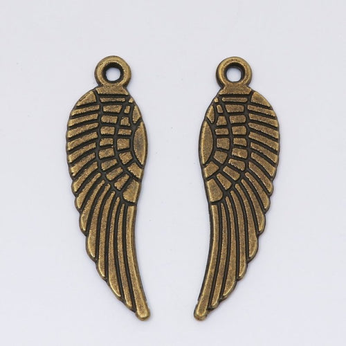 Close view of the textured angel wing charm surface and relief