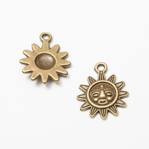 Close front and reverse view of the metal sun-face flower charm