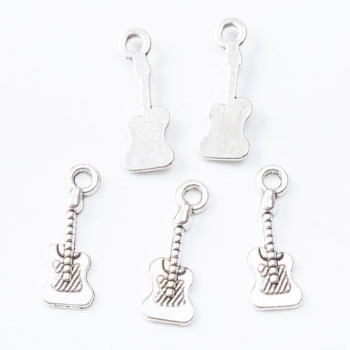 Close-up view of the mixed electric guitar metal charms in three finishes showing its front and reverse metal details.