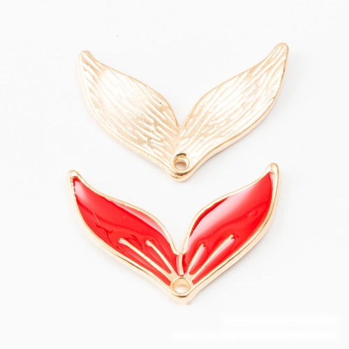 Front detail of stylized whale tail with glossy enamel and a top loop