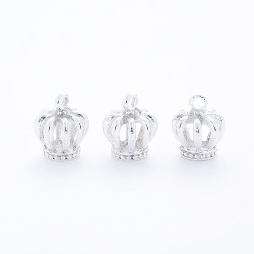 Close front and reverse view of the metal crown charm