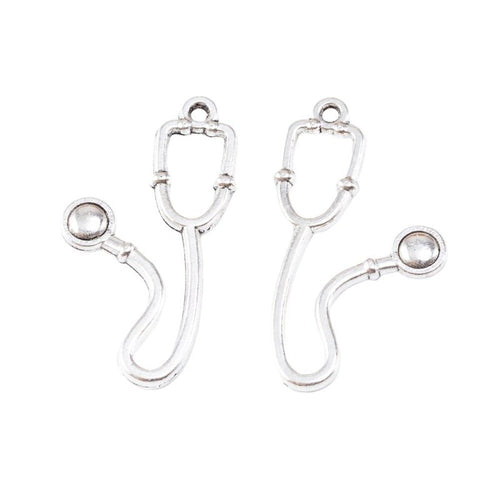 Close view of the relief and openwork details on the stethoscope metal charm