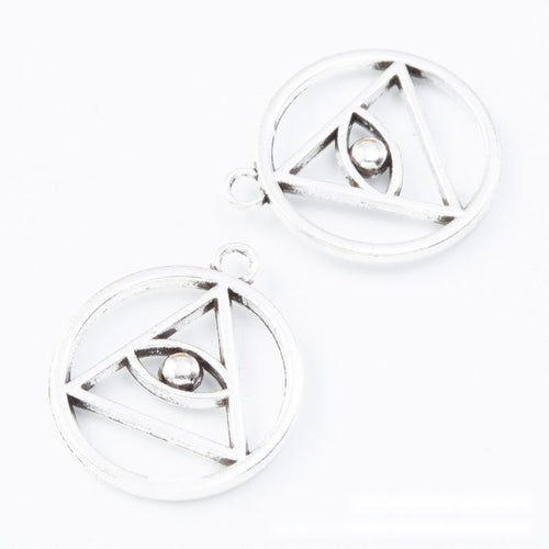 Close view of the round triangle eye charm showing its raised front pattern