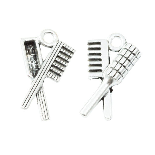 Crossed Comb And Brush Charm in an antique tone shown from the front