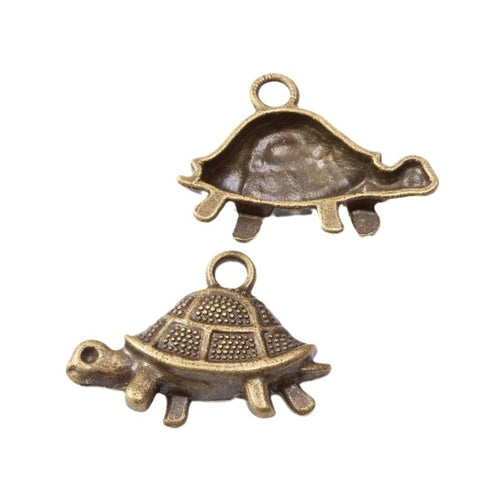 Side-view turtle charms with domed textured shells shown from the front on a white background.