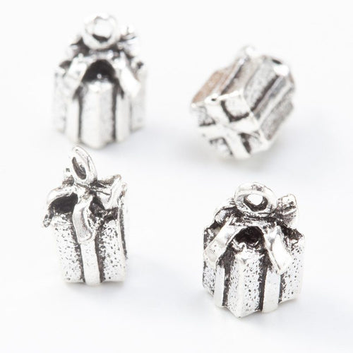 Detail view of tiny wrapped gift charm showing finish variation 2