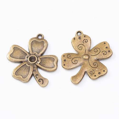 Close product view showing the front and reverse details of the four leaf clover charm