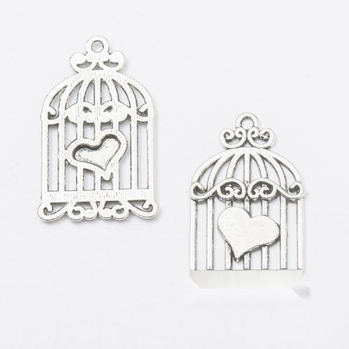 Antique Bronze, Gold Tone, Antique Silver heart birdcage charm shown in a detailed product view