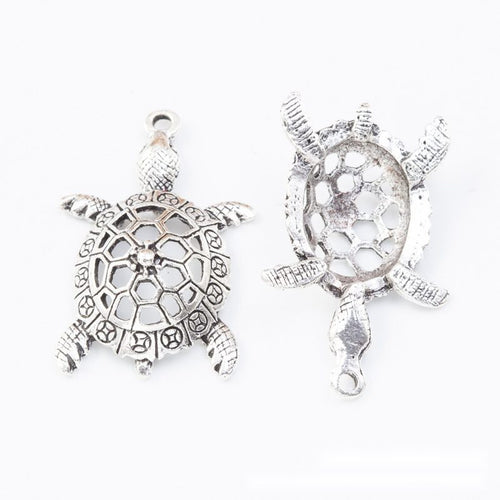Close view of the sea turtle charm showing its raised front pattern