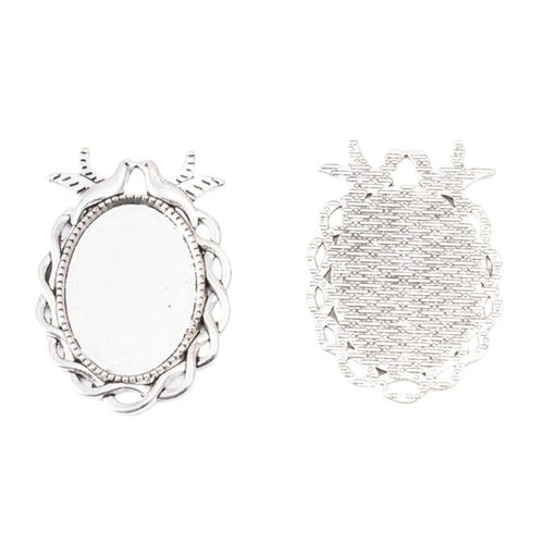 Close front view showing the shape and recessed details of the bird frame oval cabochon settings
