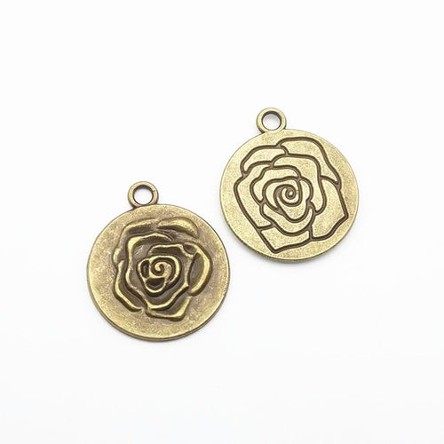 Rose medallion metal component, front and reverse detail on white