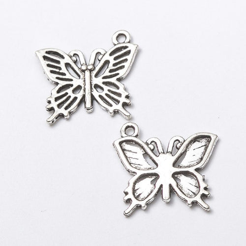 Front and reverse views of the layered openwork butterfly charm