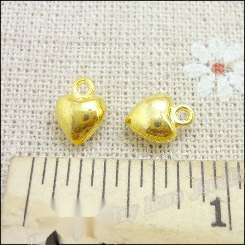 Gold Tone mini heart charm shown in a detailed product view