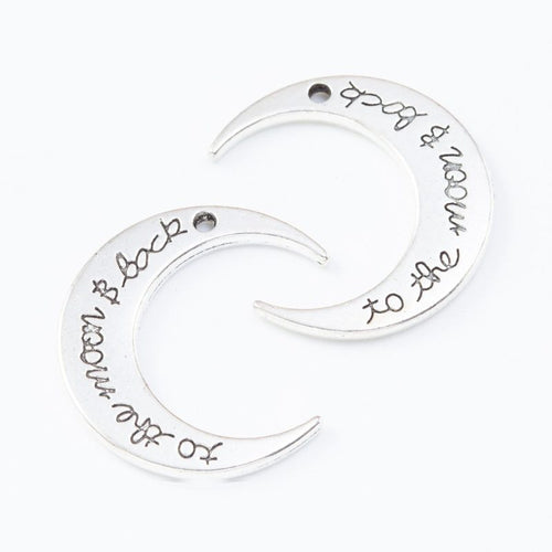 Detailed view of crescent moon with engraved lettering metal component
