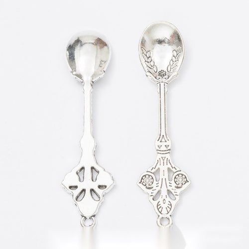 Front detail and finish comparison of the ornate miniature spoon charm