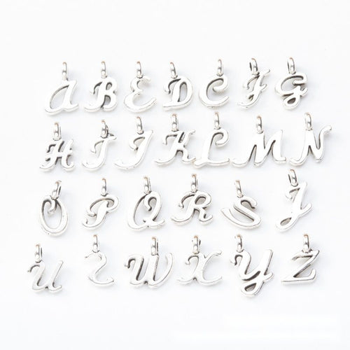 Script alphabet set metal component, front and reverse detail on white