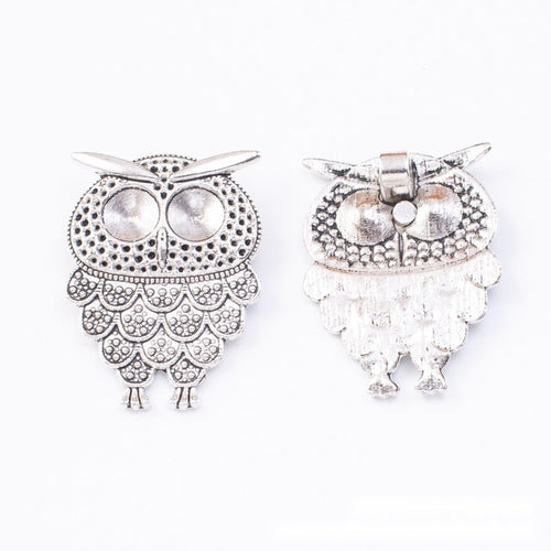 Close view showing the front and reverse details of the ornate wide wing owl charm