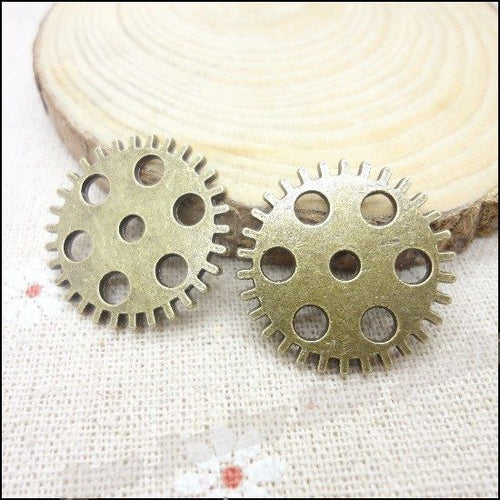 Close view showing the front details of the perforated gear charms