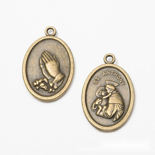 Close front view showing the shape and recessed details of the praying hands oval medal charms