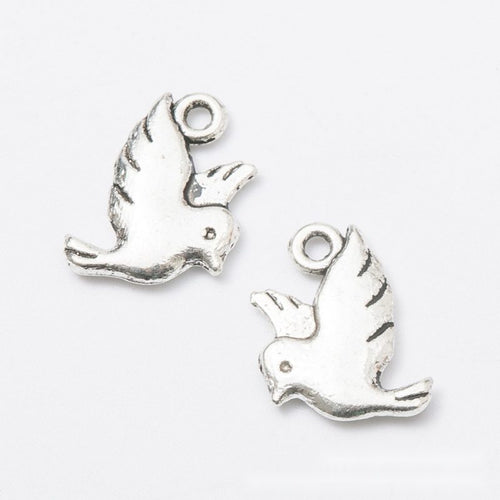Antique Bronze, Antique Silver flying bird charm shown in a detailed product view