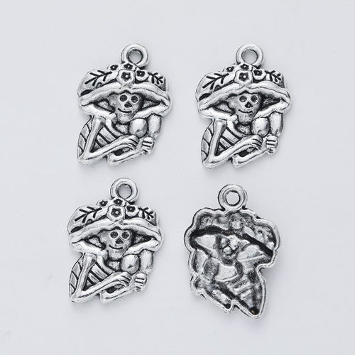 Detail view of floral-hat skeleton figure charm showing finish variation 2