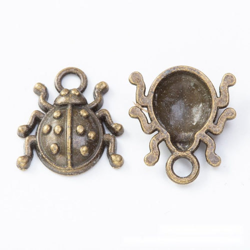 Front and reverse details of beetle charms on a white background